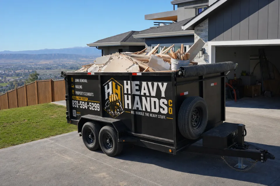 Heavy Hands Co. dump trailer loaded for Construction & Debris Removal in Hollister, California